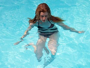 Woman swimming enjoying sports while pregnant
