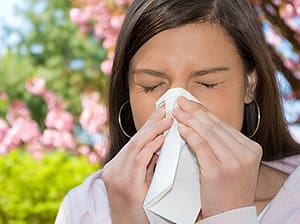 woman with allergies and sneezing
