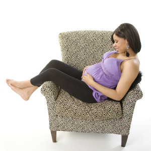 Pregnant Woman in Spotted Chair experiencing patches of darker skin during pregnancy