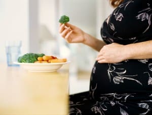 woman eating healthy food and avoiding salt during pregnancy