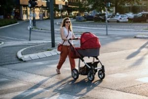 mom walking downtown with her newborn baby