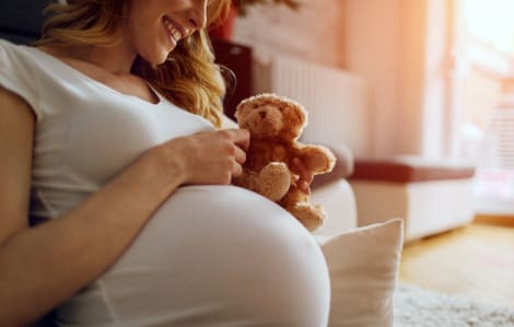 smiling at teddy bear, ready for baby after 10 things to do