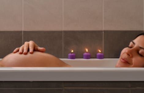 Pregnant woman blissed out in the bath