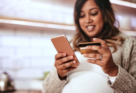 Pregnant woman shopping online for genius pregnancy items