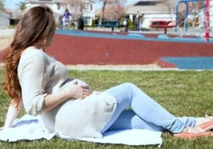 Pregnant woman relaxing at a park