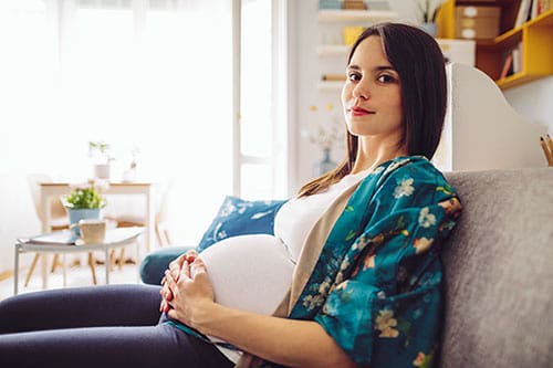 Pregnant woman in her third trimester happy for finding genius pregnancy hacks