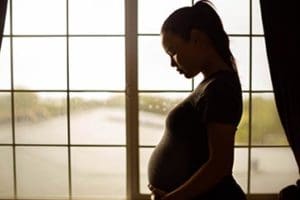 pregnant woman thinking about getting help